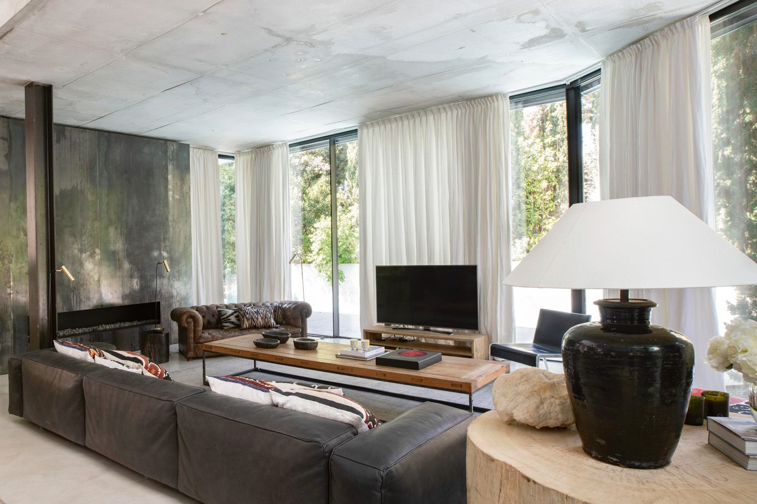 Off-white curtains provide privacy and add a tactile layer to the space
