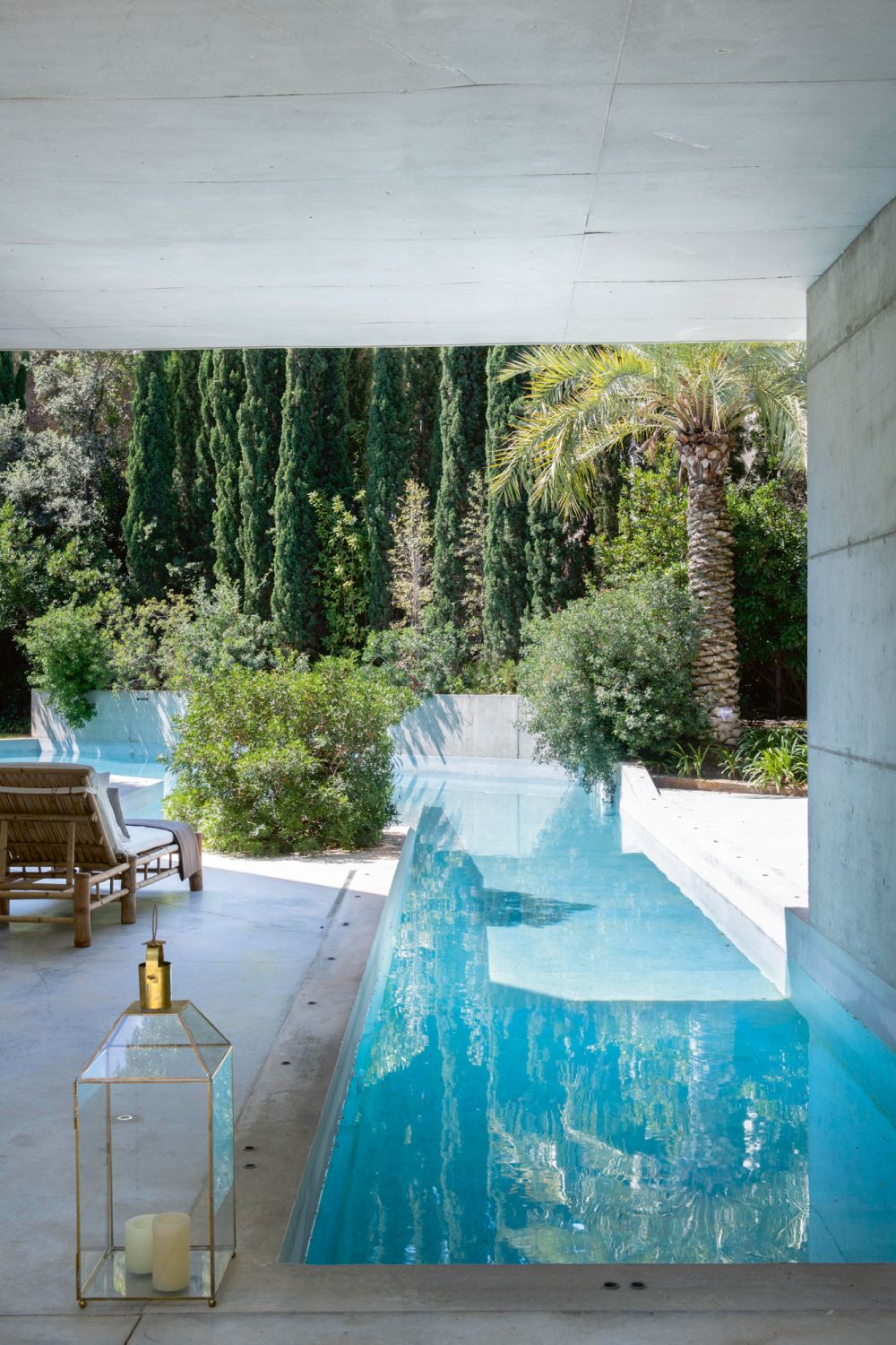The outdoor pool deck leads the eye towards the flourishing verdant views