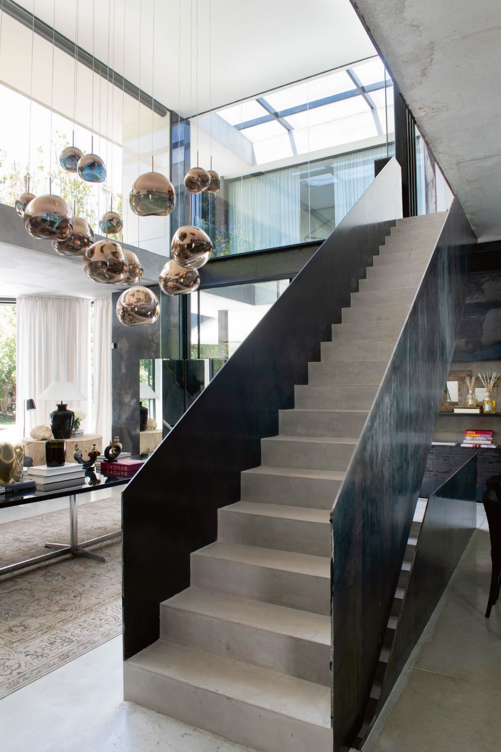A group of Tom Dixon Globe pendant lamps makes a striking sight by the staircase