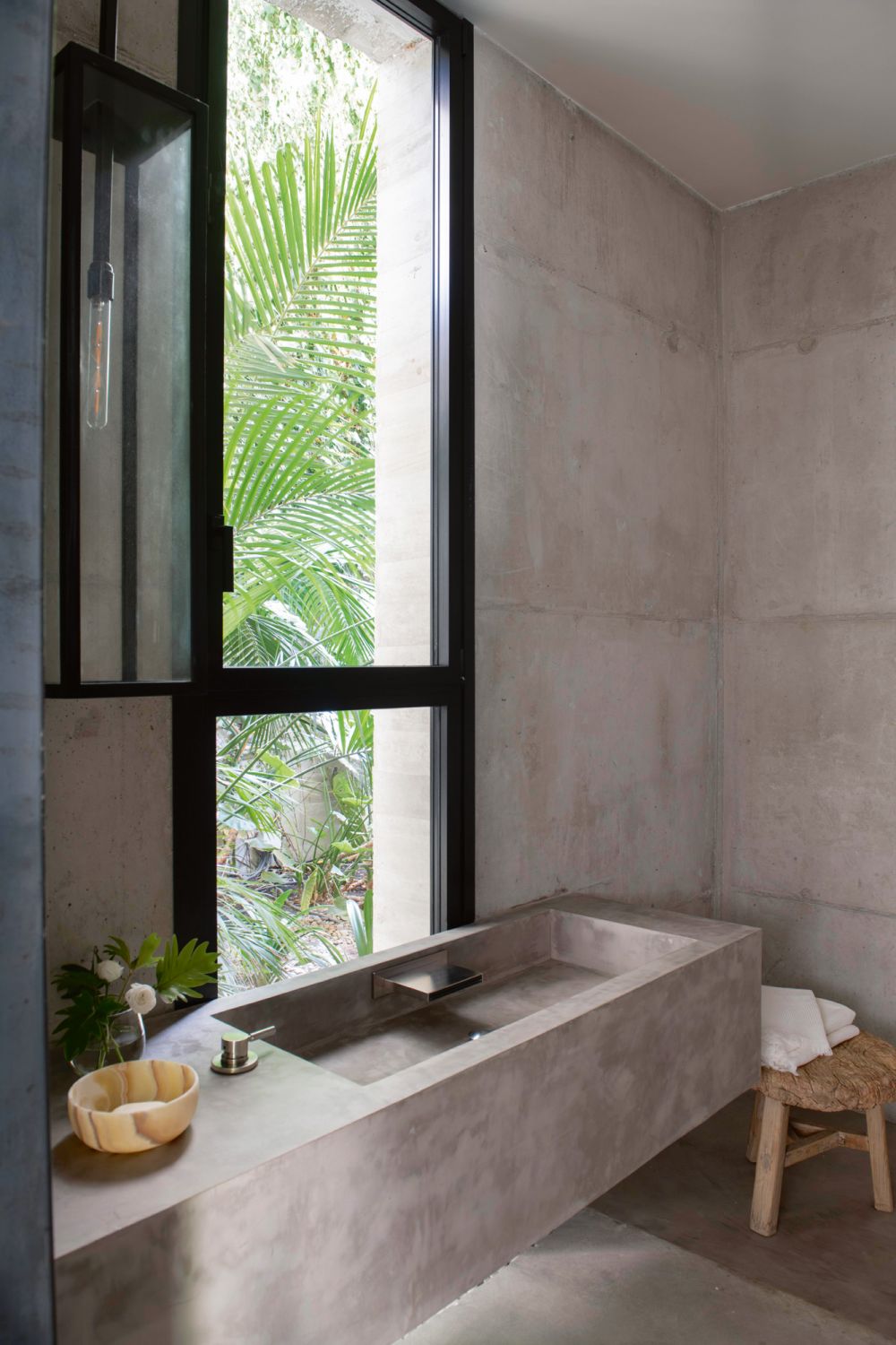 This bathroom is an understated concrete box designed to create a tranquil mood