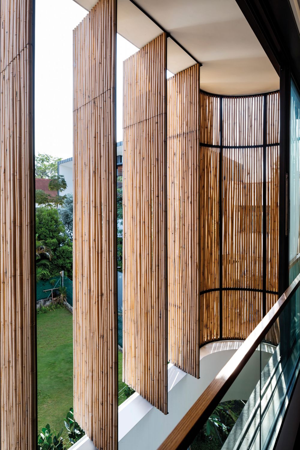 The bamboo screens used in this house by Wallflower Architecture add a rustic touch to the facade (Image: Marc Tey)