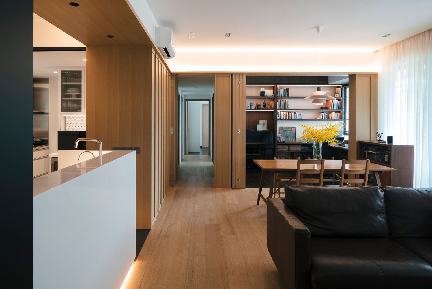 This apartment by JOW Architects offers the owners extra flexibility with the use of space in the open-plan living and dining room and the kitchen