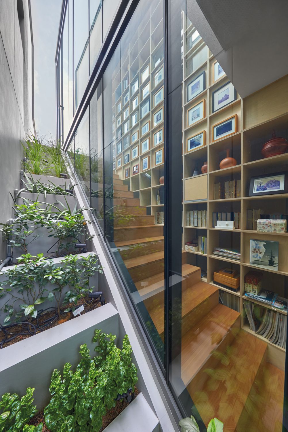 RT+Q co-founder Rene Tan’s home features a terraced garden beside the main staircase and shelves lined with memorabilia and books (Image: Jasper Yu)