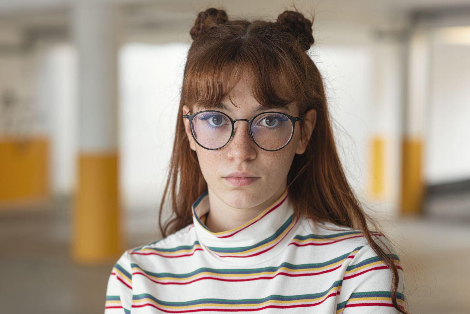 Portrait of Young woman wearing nerd glasses standing in underground parching