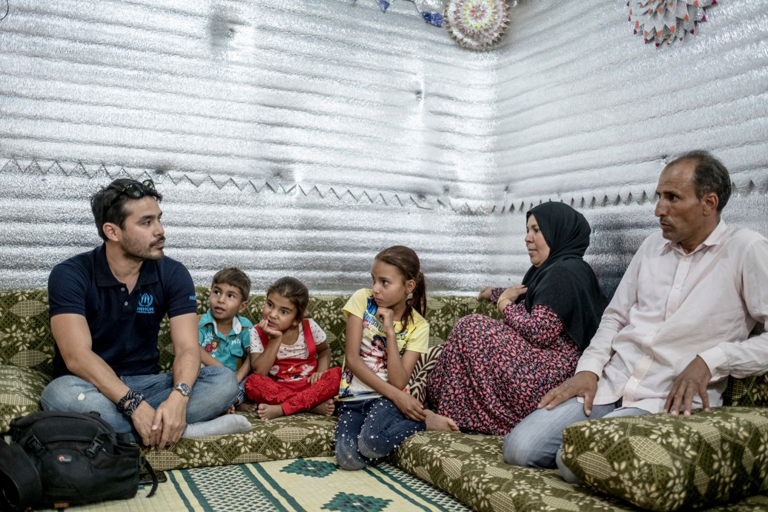 AMMAN, JORDAN JULY 30, 2018 - UNHCR High profile supporter and broadcast journalist from the Philippines, Atom Araullo, meets with Eid Al-ZLefan(father) and Um JIhan (mother) and their family who fled from Syria at the height of the conflict. Situtated at 90kms from the Syrian border, the Azraq camp houses over 35,000 refugees since it opened in 2014. There are over 700,000 refugees in Jordan as of June 2018 and only 20% of them live inside the three camps provided by the government. Veejay Villafranca/U