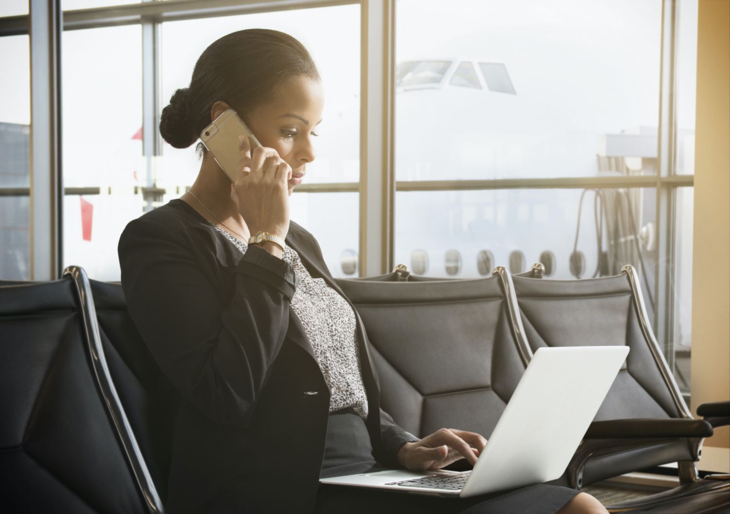 Businesswoman working in airport waiting area