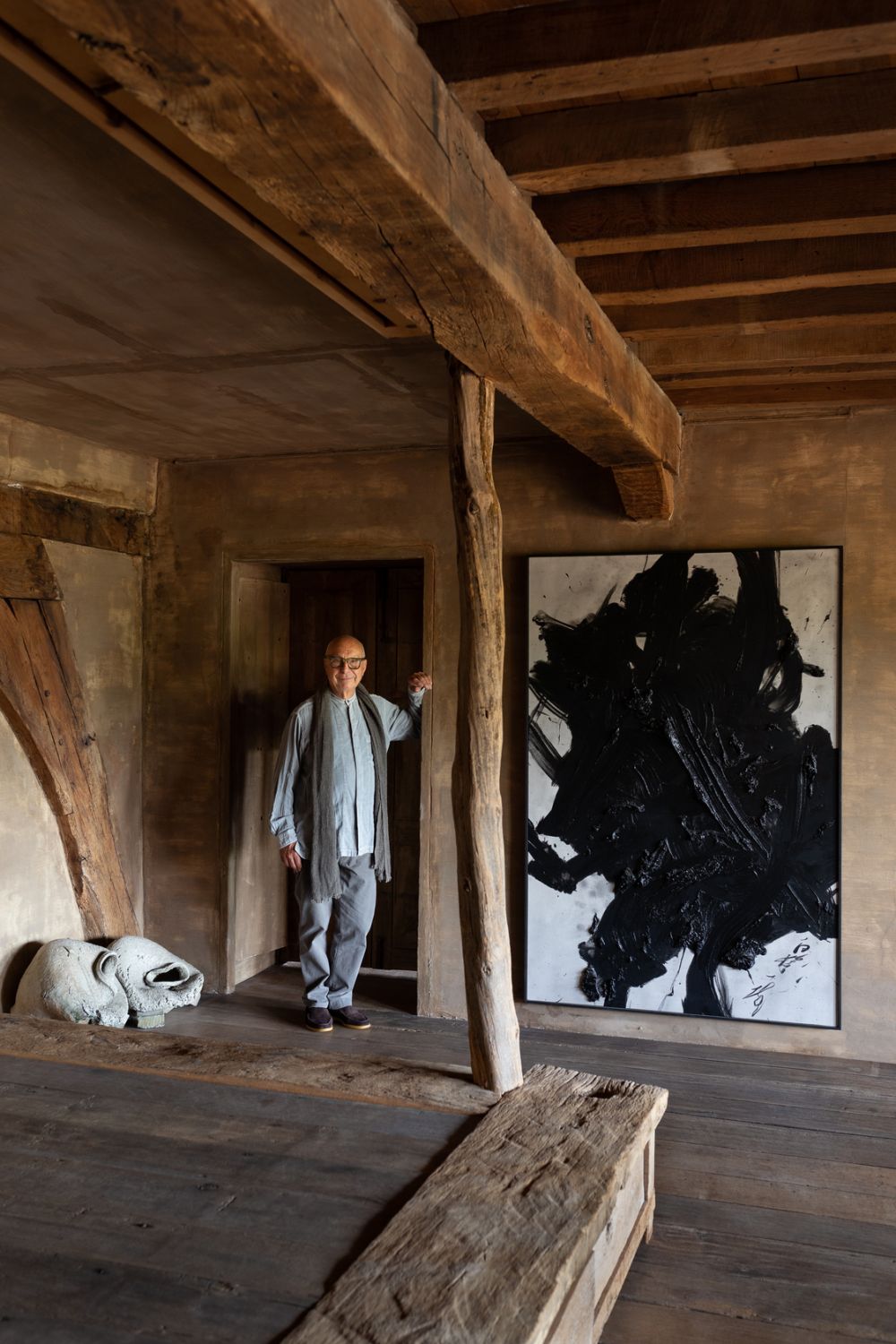 Axel Vervoordt in his wabi room next to Kazuo Shiraga’s Yuboku II (1989), Photo: Isabelle Pateer