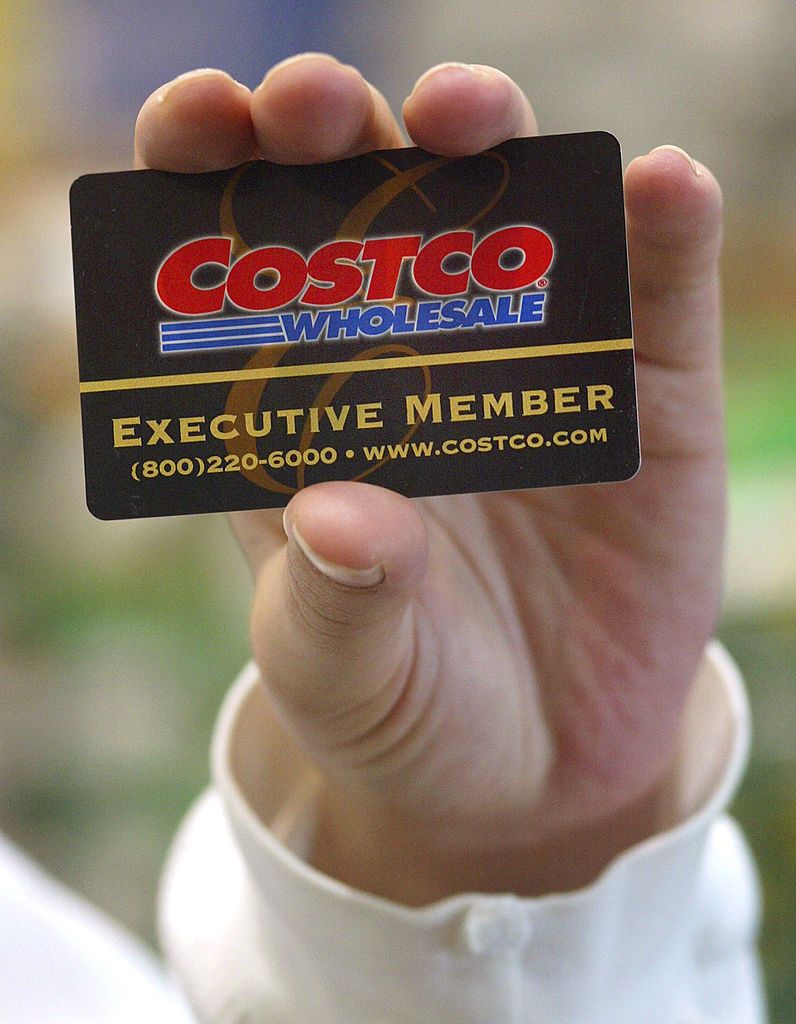 402065 08: A shopper displays her Costco Wholesale membership card as she enters a Costco Wholesale store March 8, 2002 in Niles, IL. Warehouse retailer Costco Wholesale Corp. has reported higher quarterly profits as the promise of bulk goods at bargain prices resonated with consumers in the U.S. recession. Warehouse retailers charge customers an annual membership fee, typically $35 to $45, to shop at clubs that offer deep discounts on bulk quantities of items like food and household cleaners. (Photo by Tim