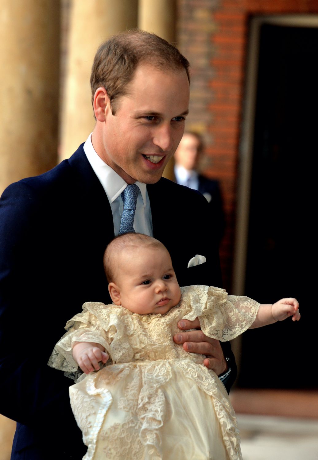LONDON, ENGLAND - OCTOBER 23:  Prince William, Duke of Cambridge arrives, holding his son Prince George, at Chapel Royal in St James's Palace, ahead of the christening of the three month-old Prince George of Cambridge by the Archbishop of Canterbury on October 23, 2013 in London, England. (Photo by John Stillwell - WPA Pool /Getty Images)