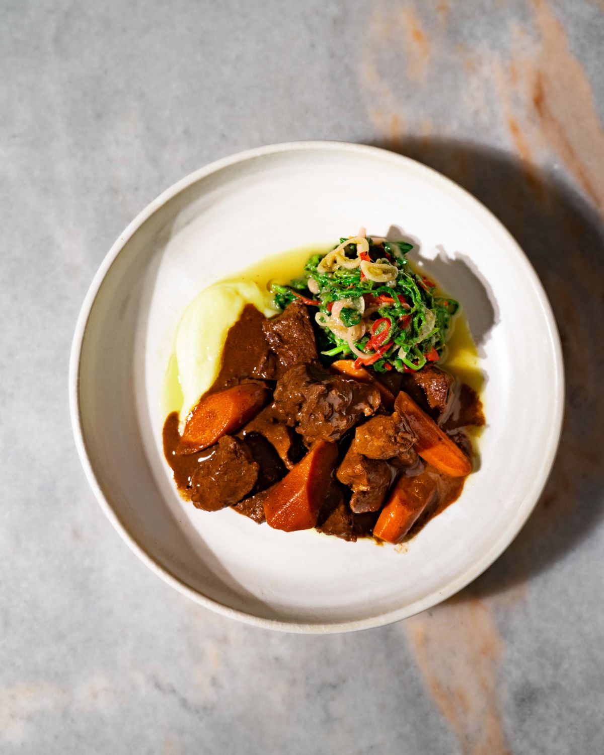 LI Restaurant's Easter lamb shank captured from the top down to highlight its plating