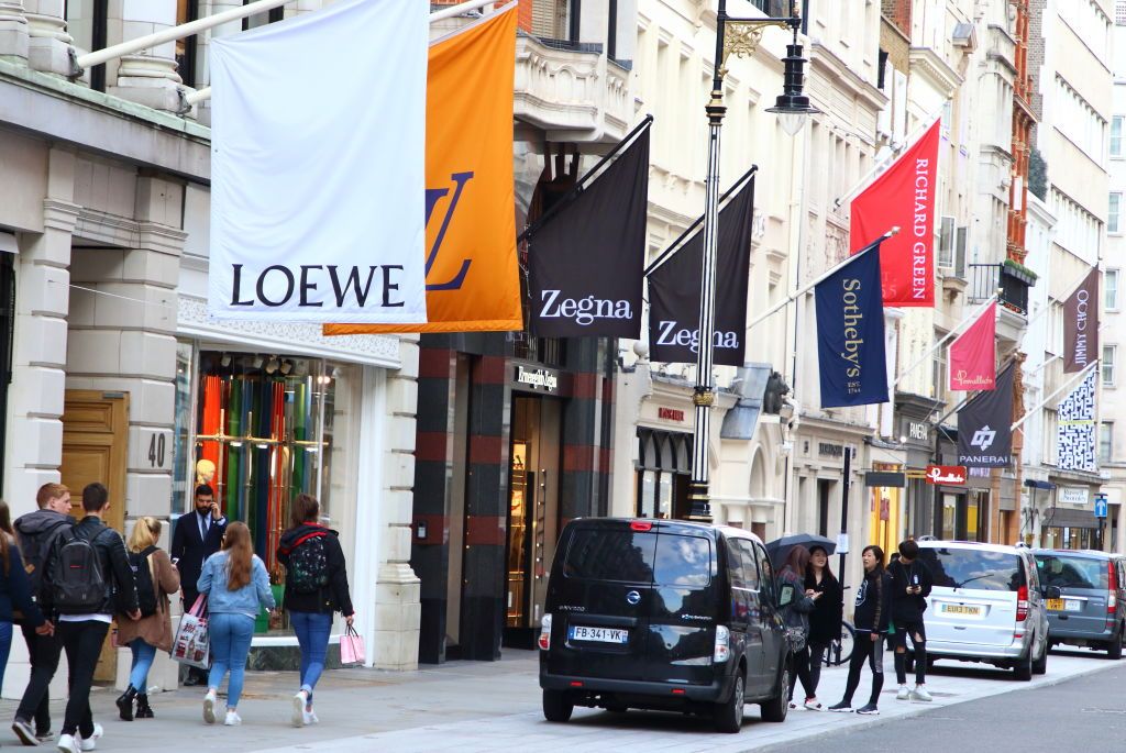 LONDON, UNITED KINGDOM - 2019/09/26: Flags of various brands and logos line the streets in the Luxury Fashion and Jewellery shopping area on London's New Bond Street. (Photo by Keith Mayhew/SOPA Images/LightRocket via Getty Images)