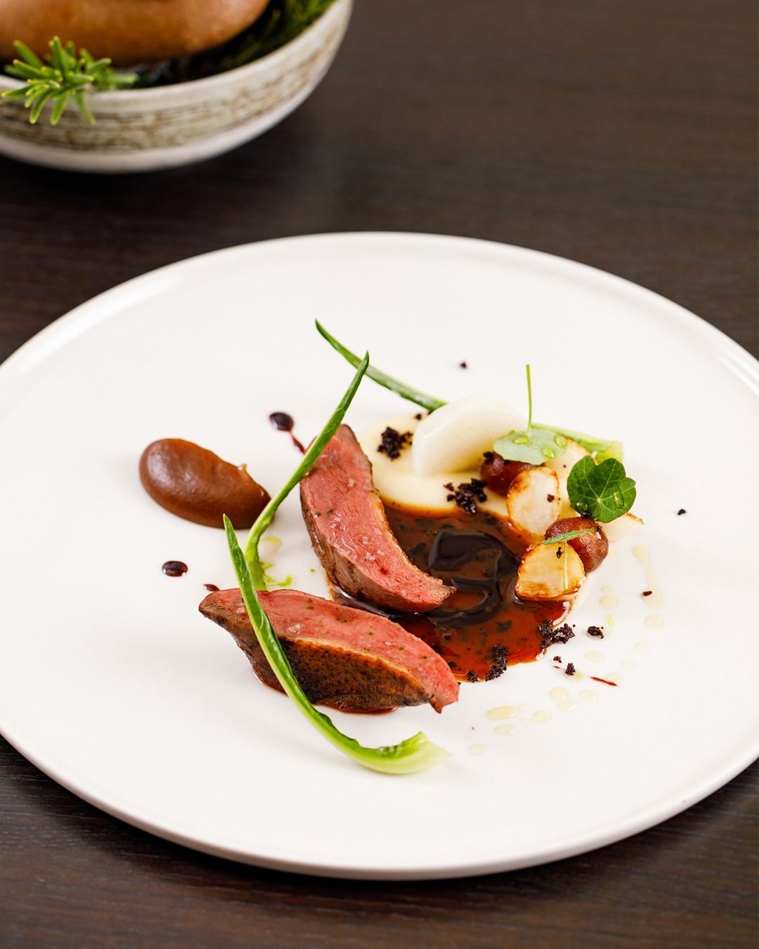 Squab pigeon cooked on the barbecue, served with dates, turnips and black olives (Photo: @restaurantadams/Instagram)
