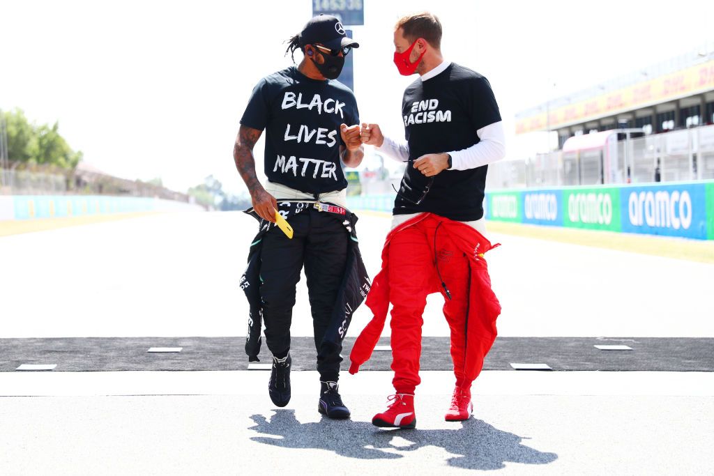 BARCELONA, SPAIN - AUGUST 16: Lewis Hamilton of Great Britain and Mercedes GP and Sebastian Vettel of Germany and Ferrari talk on the grid before the F1 Grand Prix of Spain at Circuit de Barcelona-Catalunya on August 16, 2020 in Barcelona, Spain. (Photo by Dan Istitene - Formula 1/Formula 1 via Getty Images)
