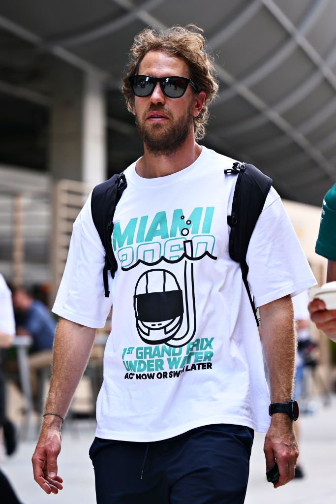 MIAMI, FLORIDA - MAY 05: Sebastian Vettel of Germany and Aston Martin F1 Team walks in the Paddock during previews ahead of the F1 Grand Prix of Miami at the Miami International Autodrome on May 05, 2022 in Miami, Florida. (Photo by Clive Mason - Formula 1/Formula 1 via Getty Images)