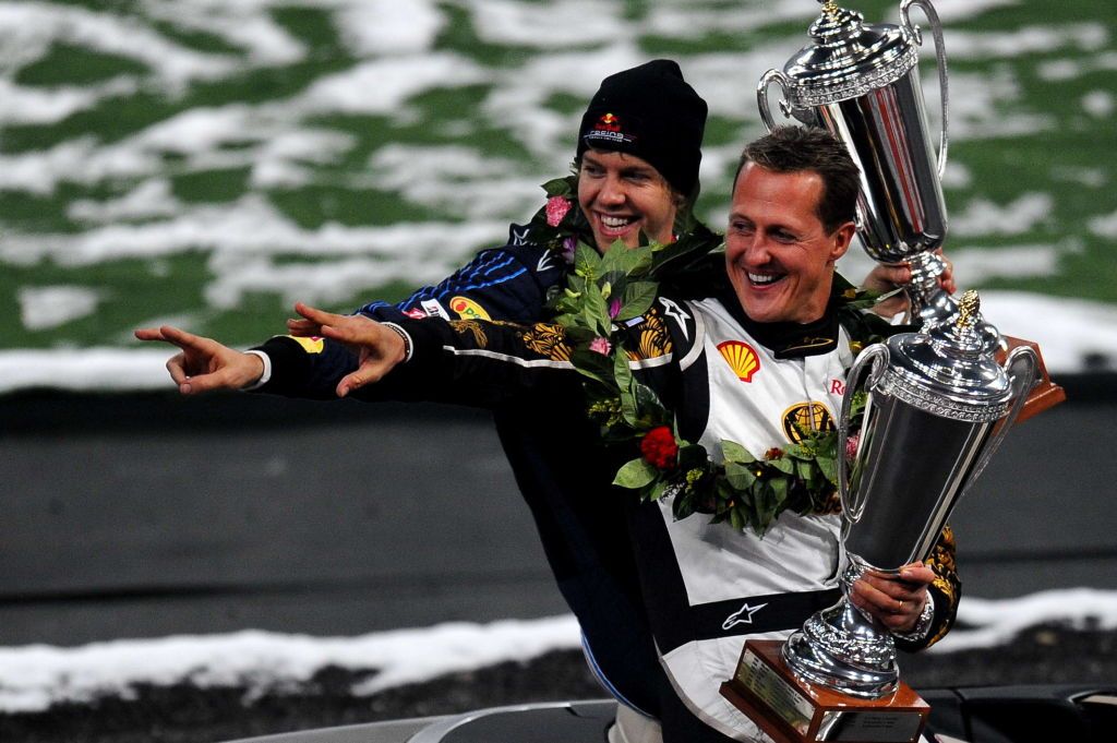 BEIJING CHINA - NOVEMBER 3, 2009: (CHINA OUT) German drivers Michael Schumacher (R) and Sebastian Vettel (L) celebrate with the awards after Nations Cup Race of Race of Champions Beijing 2009 at Birds Nest on November 3, 2009 in Beijing, China. (Photo by Visual China Group via Getty Images)