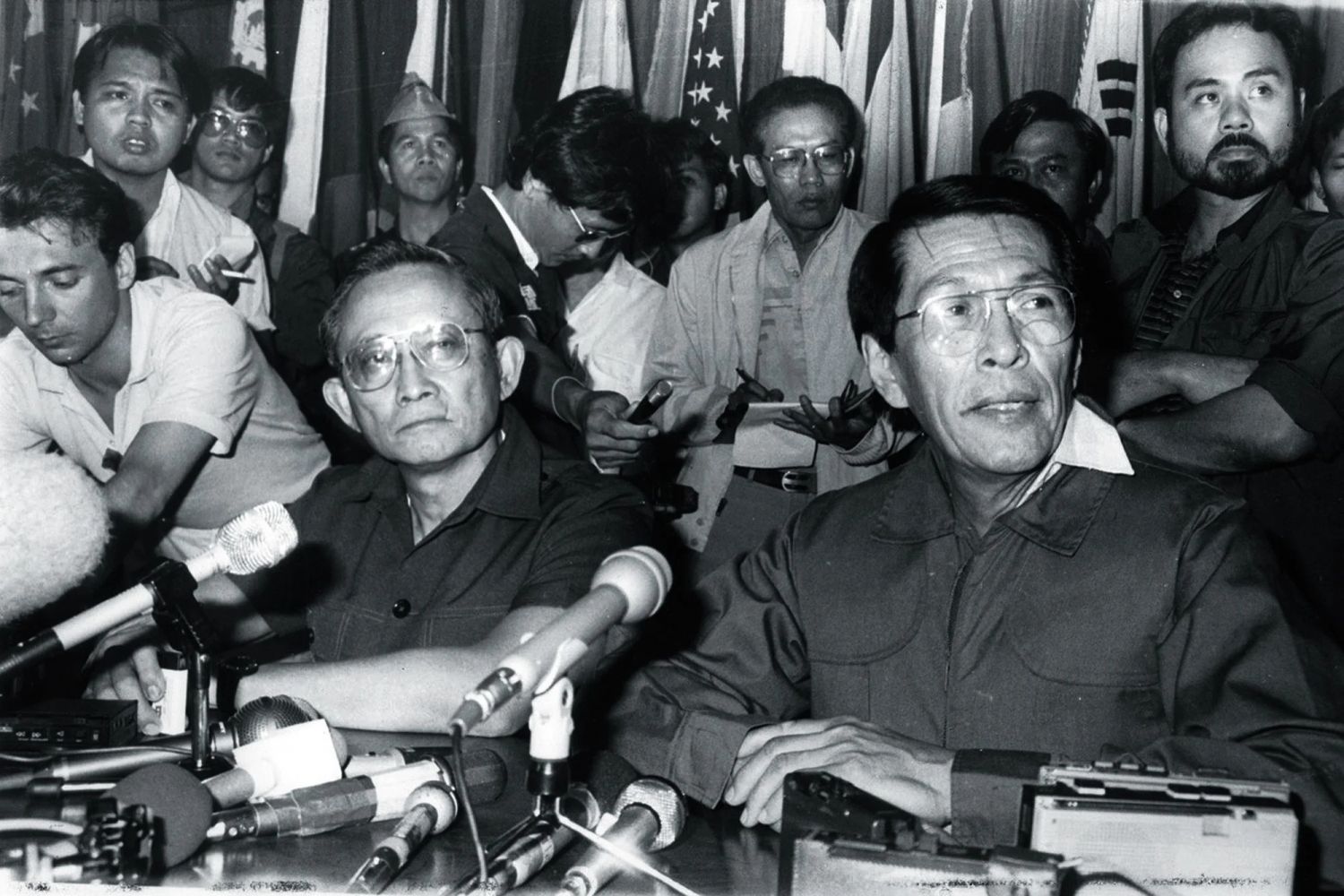 Ramos and Enrile announcing their withdrawal of support for Marcos in a press conference