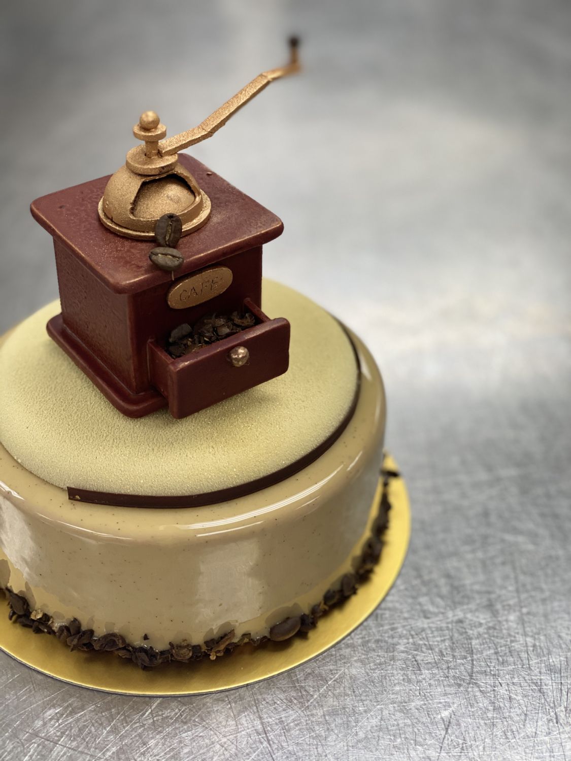 A coffee grinder crafted in chocolate