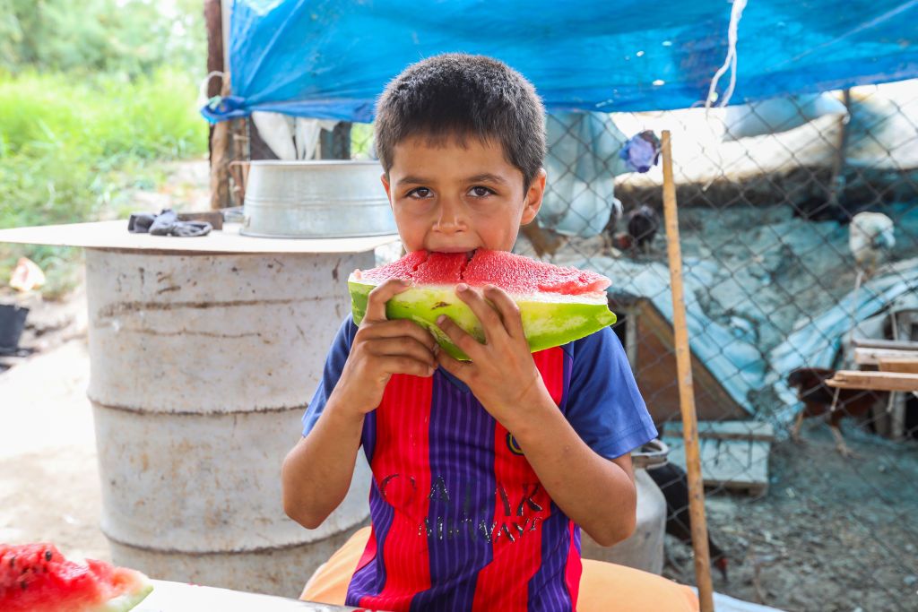 SABIRABAD, AZERBAIJAN - JULY 25: A child wearing Barcelona's jersey of Argentinian Lionel Messi eats watermelon in a field in Sabirabad district on July 25, 2020.