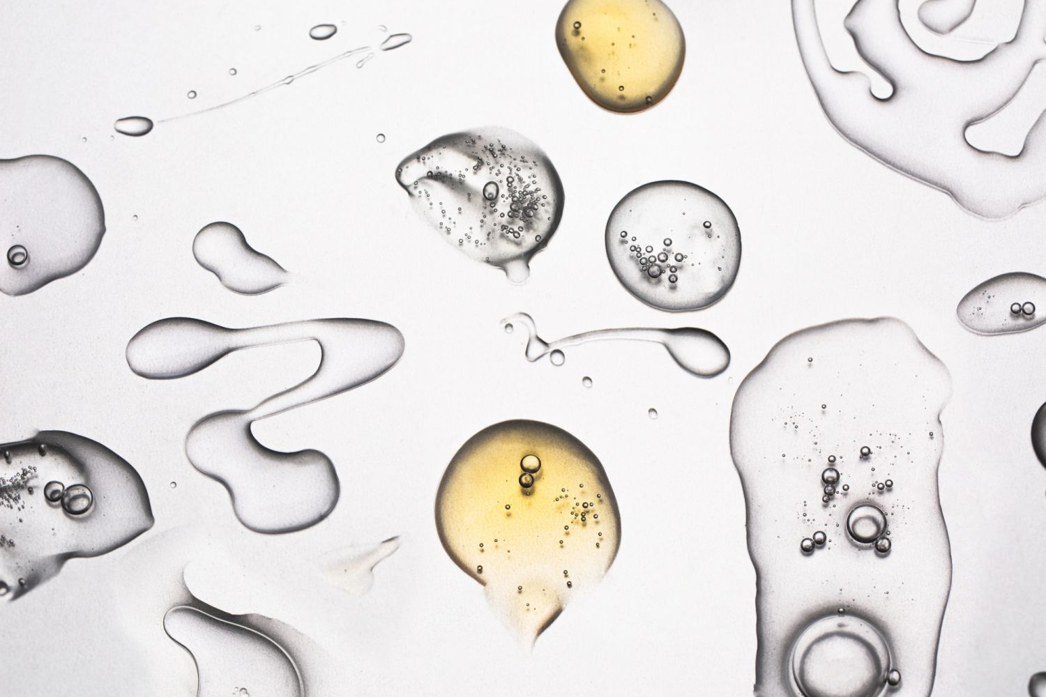 Drops of serum and oil. Care cosmetics concept. Flat lay style.