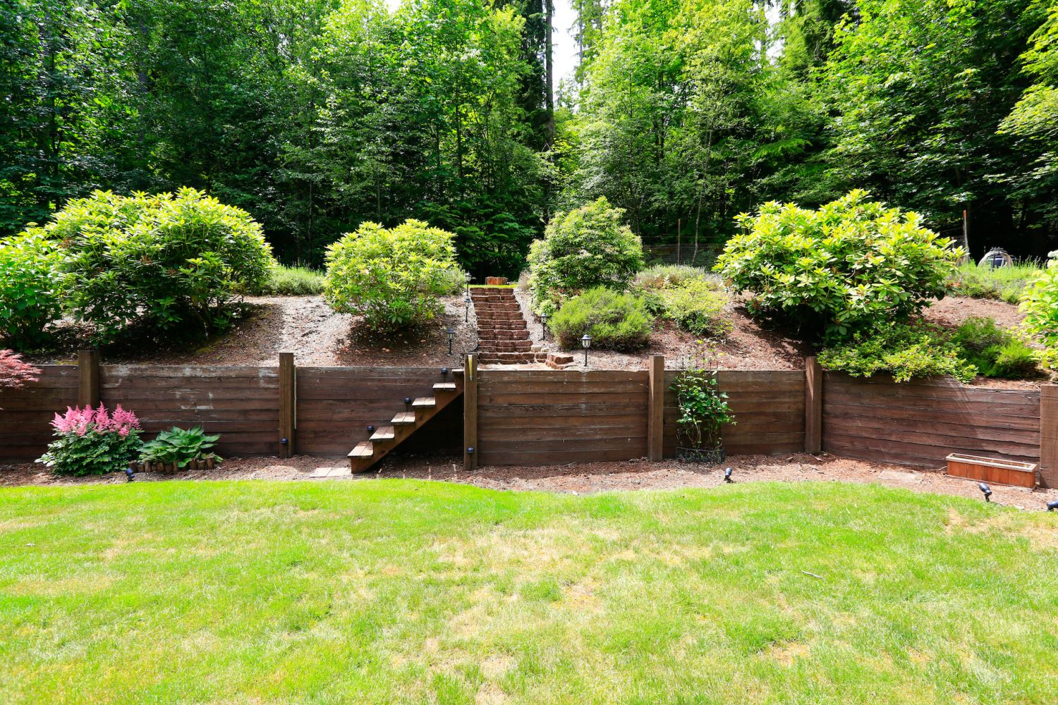 Beautiful backyard landscape and garden view. Garden with wooden trim and stairs