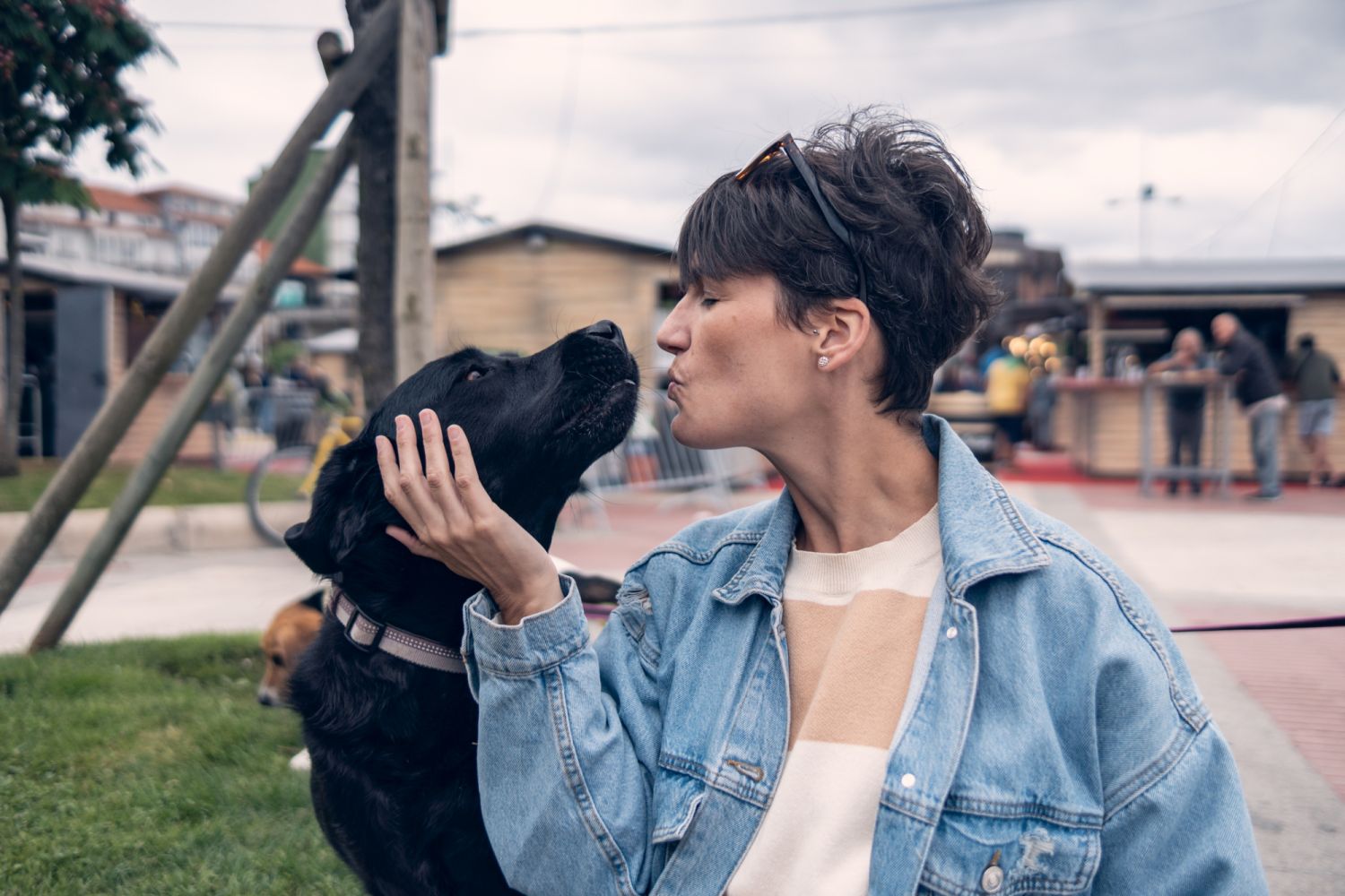 a woman kissing her dog