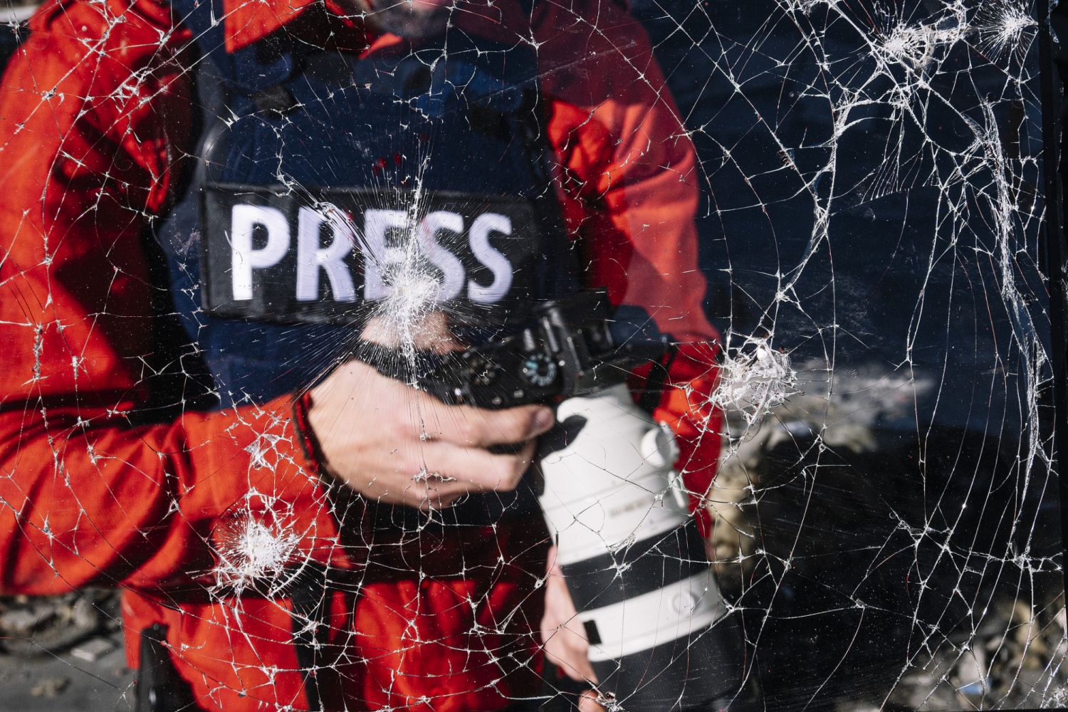 One man, war journalist with digital camera at the place of action, in war zone.