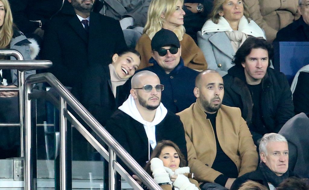 PARIS, FRANCE - NOVEMBER 28: Leonardo DiCaprio and his girlfriend Camila Morrone, below DJ Snake attend the UEFA Champions League Group C match between Paris Saint-Germain (PSG) and Liverpool FC at Parc des Princes stadium on November 28, 2018 in Paris, France. (Photo by Jean Catuffe/Getty Images)