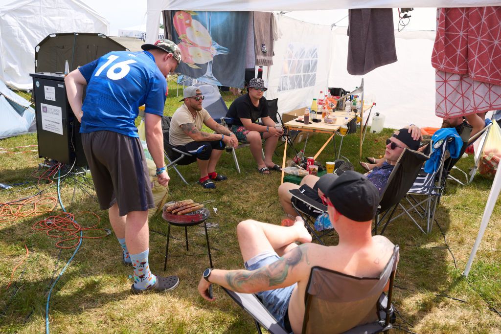 04 June 2022, Rhineland-Palatinate, Nürburg: Festival-goers at the open-air rock festival "Rock am Ring" barbecue for breakfast at a camping area near the Eifel race track. The festival is sold out with 90,000 visitors. Photo: Thomas Frey/dpa (Photo by Thomas Frey/picture alliance via Getty Images)