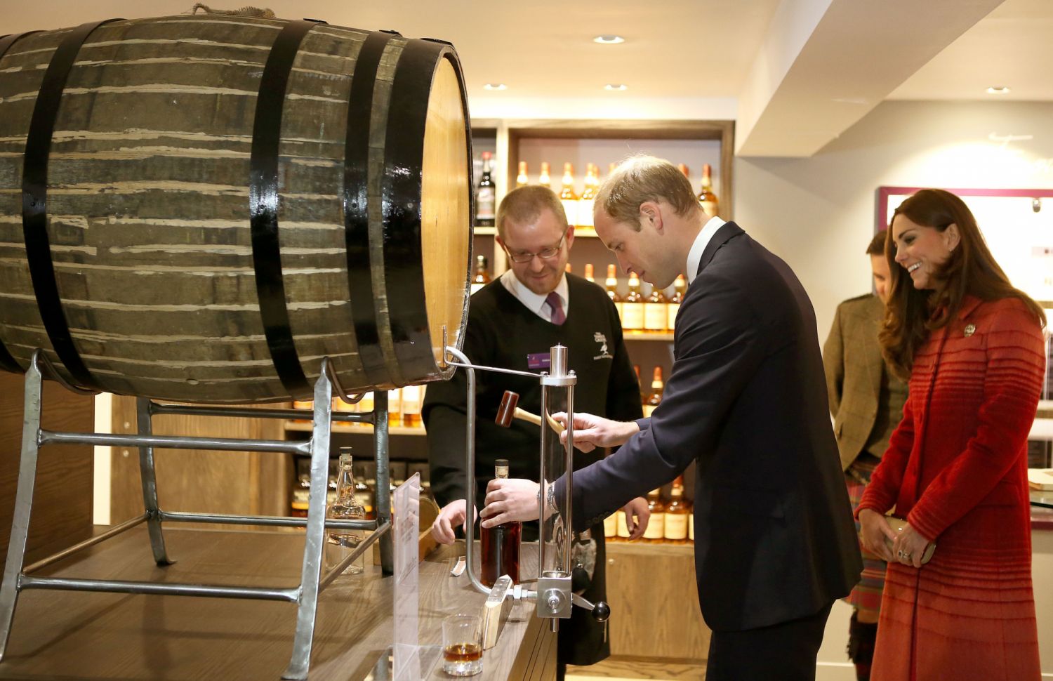 The Duchess of Cambridge watches as the Duke of Cambridge hammers the cork into a bottle of Glenturret Single Malt whisky during a tour of The Famous Grouse Distillery in Crieff, Scotland. (Photo by Andrew Milligan/PA Images via Getty Images)