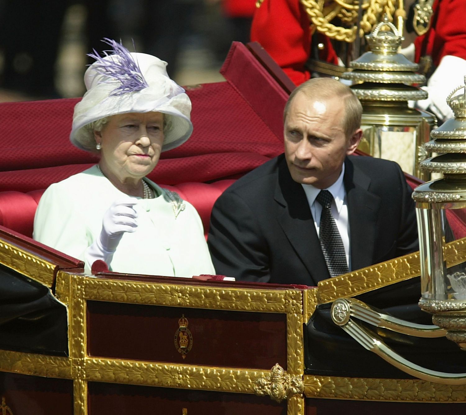 LONDON - JUNE 24: Russian President Vladimir Putin is accompanied by Her Majesty The Queen during a procession at The Mallat during the start iof his state visit on June 24, 2003 in London, England. Putin is on a 4 days visit in Great Britain and will attend a number of functions during his time in the country. The visit is the first by a Russian President since 1843. (Photo by Julian Herbert/Getty Images)
