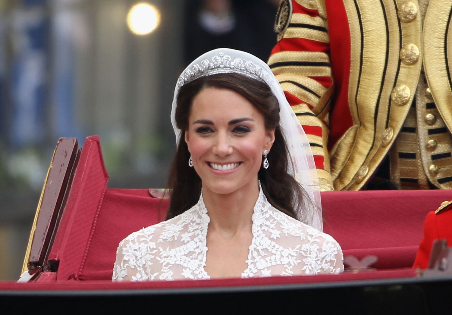 LONDON, ENGLAND - APRIL 29: Her Royal Highness Catherine, Duchess of Cambridge journeys by carriage procession to Buckingham Palace following her marriage to Prince William, Duke of Cambridge at Westminster Abbey on April 29, 2011 in London, England. The marriage of the second in line to the British throne was led by the Archbishop of Canterbury and was attended by 1900 guests, including foreign Royal family members and heads of state. Thousands of well-wishers from around the world have also flocked to Lo