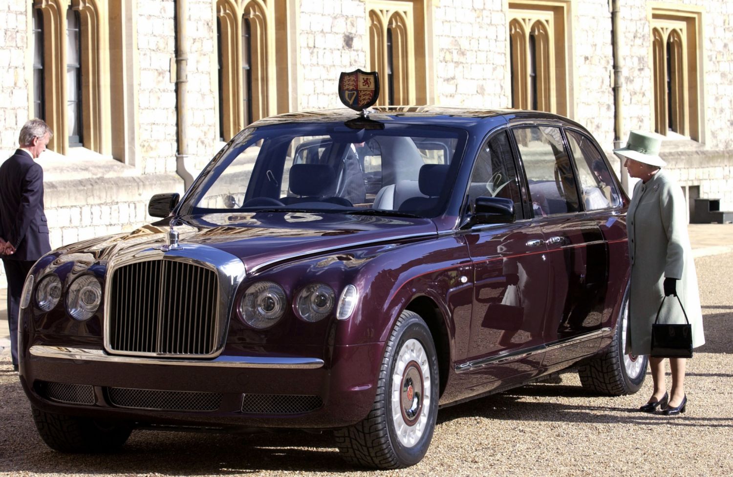 WINDSOR, UNITED KINGDOM - MAY 29: Queen Elizabeth II At Windsor Castle Inspecting The New Bentley State Limousine Car Presented To Her As A Golden Jubilee Gift On Behalf Of A Consortium Of British-based Automotive Manufacturing And Service Companies. The Car Has Been Fully Fitted To Withstand Terrorist Attacks. The Queen Is The Only Person Permitted To Have A Car On British Roads Without A Registration Number Plate. (Photo by Tim Graham Photo Library via Getty Images)