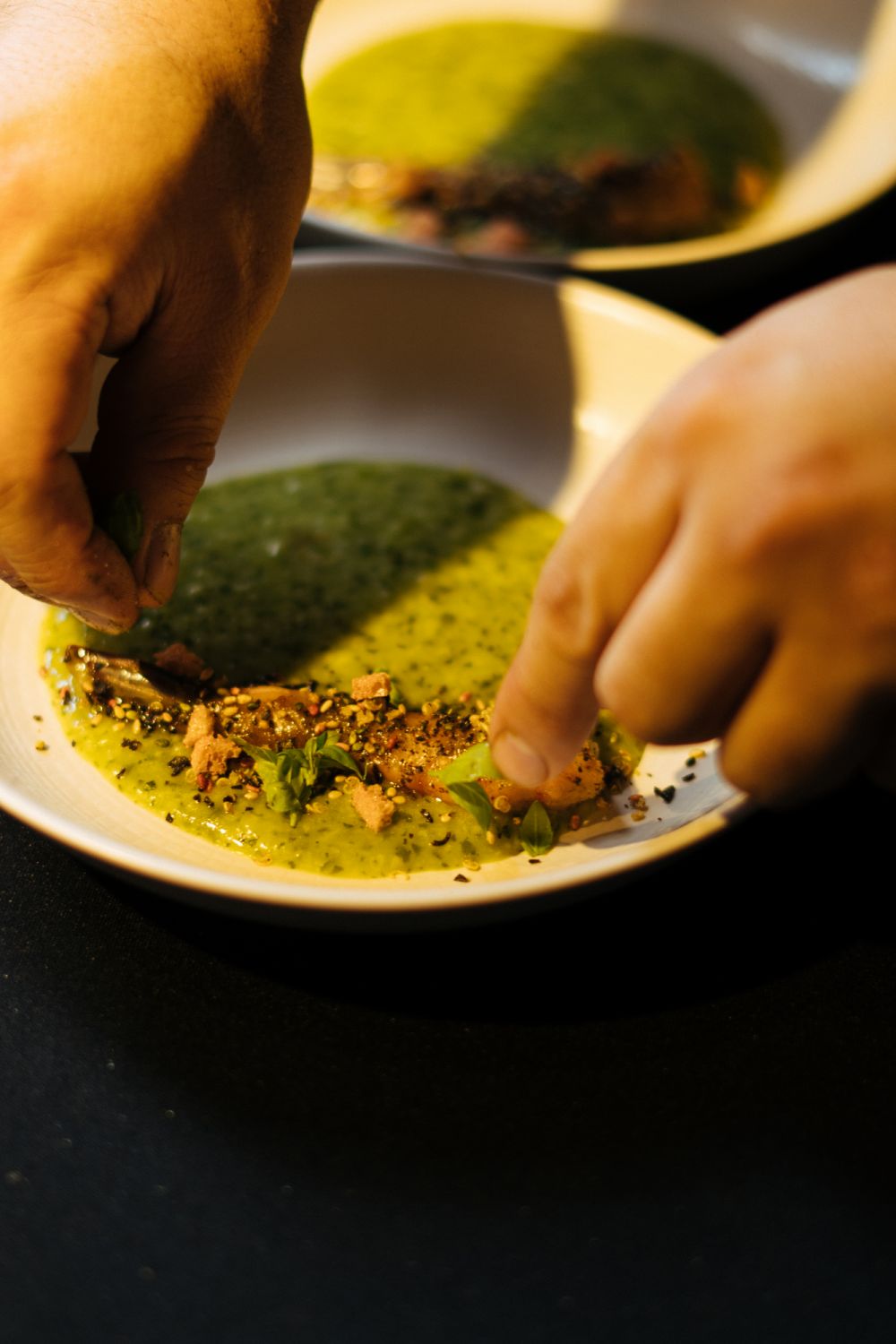 Pesto porridge with Pulau Ketam wild-caught red prawns, kombu glaze, chef's furikake, and nori ash by Chef Chai Chun Boon