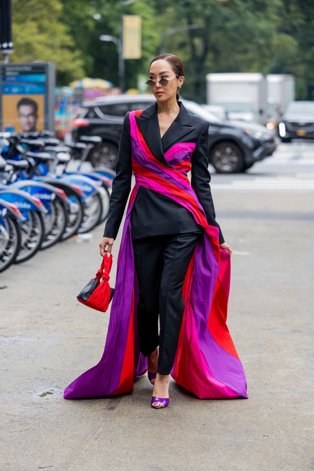 NEW YORK, NEW YORK - SEPTEMBER 12: Chriselle Lim wearing black suit, wrapped pink cape outside Carolina Herrera on September 12, 2022 in New York City. (Photo by Christian Vierig/Getty Images)