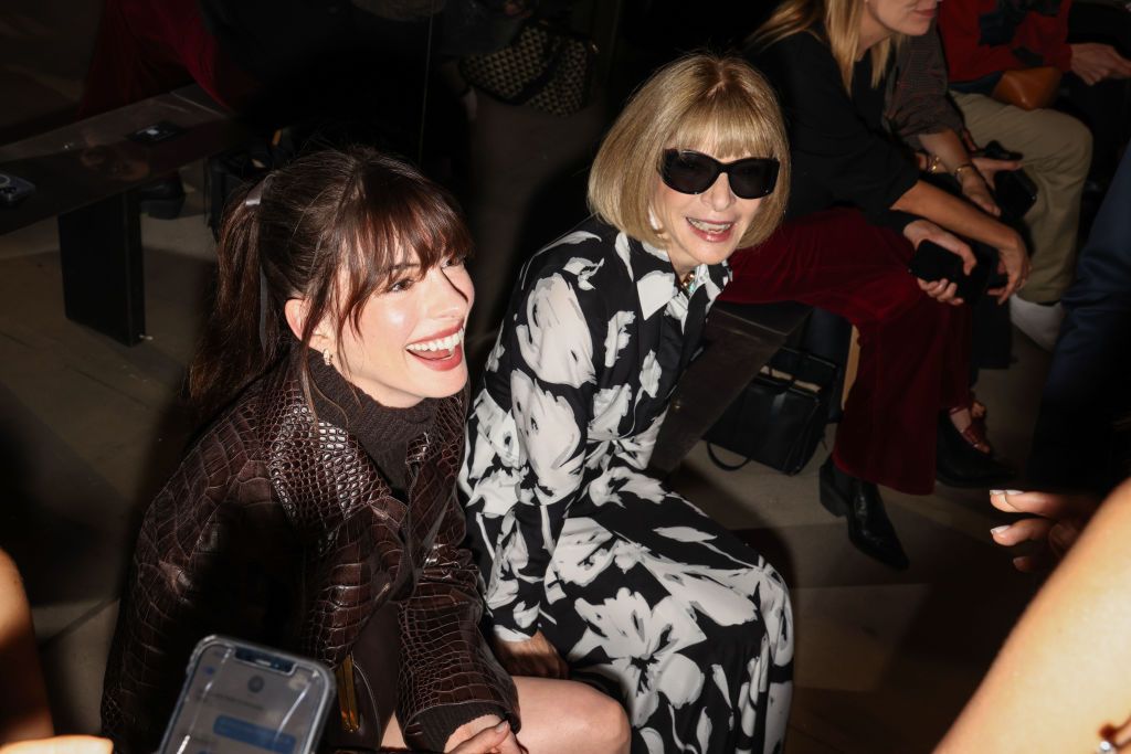 Anne Hathaway (L) and Anna Wintour attend the Michael Kors SS23 runway show at Highline Stages on September 14, 2022 in New York, NY. Credit: Rebecca Smeyne for WWD. (Photo by Rebecca Smeyne/WWD via Getty Images)