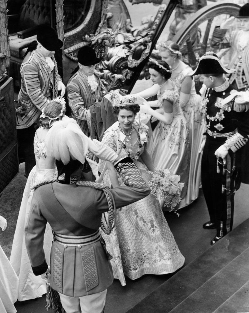 Queen Elizabeth II arrives at Westminster Abbey in the Coronation Coach wearing her Coronation robes and Sovereign crown. With her are her Maids of Honour and the Duke of Edinburgh. Original Publication: Picture Post - 6537 - The Coronation Of Queen Elizabeth - pub. 1953 (Photo by Topical Press Agency/Getty Images)