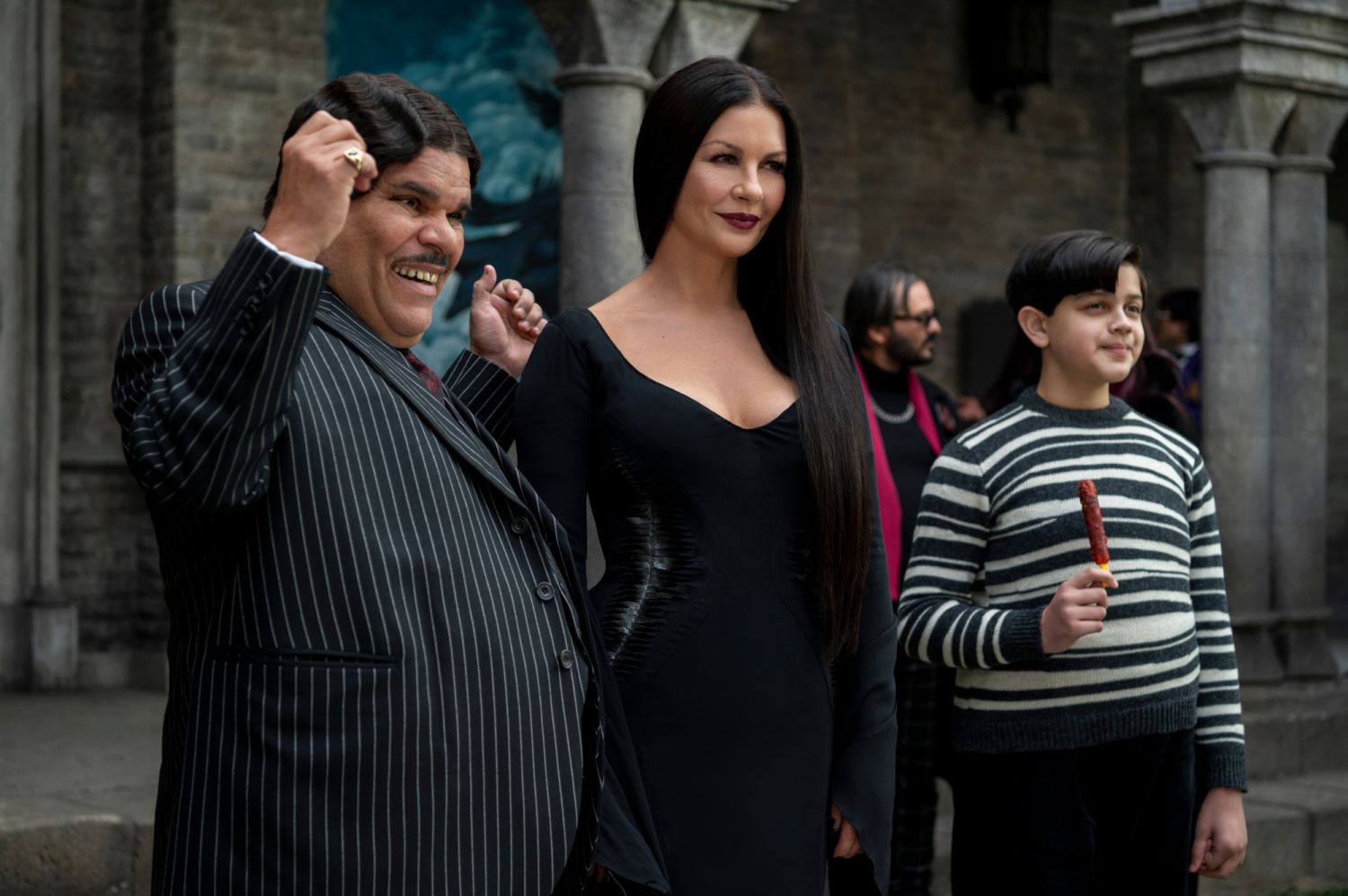 Wednesday. (L to R) Luis GuzmaÌn as Gomez Addams, Catherine Zeta-Jones as Morticia Addams, Issac Ordonez as Pugsley Addams in episode 105 of Wednesday. Photo via Netflix