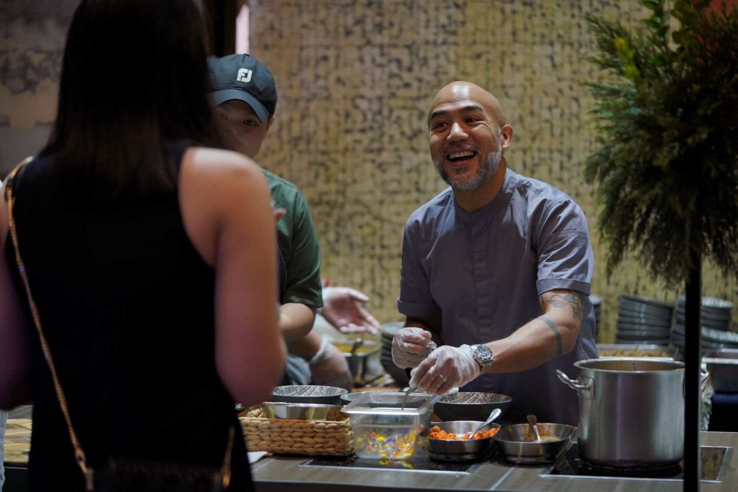 Off Menu Philippines 2022 - Chef JP Anglo greets a hungry guest as they prepare their lamb kaldereta