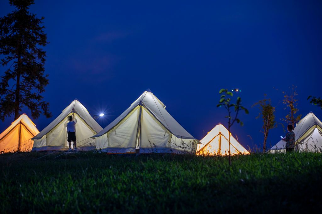 ENSHI, CHINA - AUGUST 17: A child enters a tent at a wild camping spot on Fu'er Mountain under starry sky on August 17, 2022 in Enshi Tujia and Miao Autonomous Prefecture, Hubei Province of China. (Photo by VCG/VCG via Getty Images)