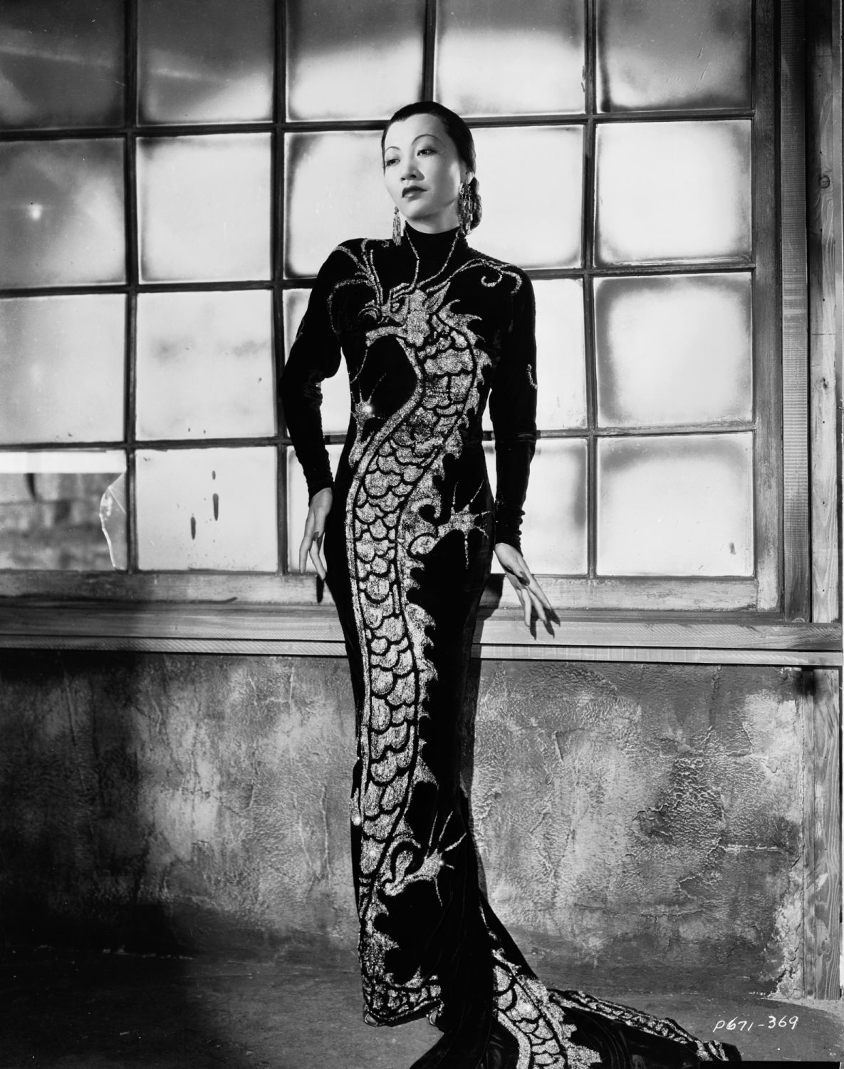 1934: Chinese-American film star, Anna May Wong (1905 - 1961) wearing a dress with dragon motif in a publicity shot for 'Limehouse Blues', directed by Alexander Hall. (Photo via John Kobal Foundation/Getty Images)