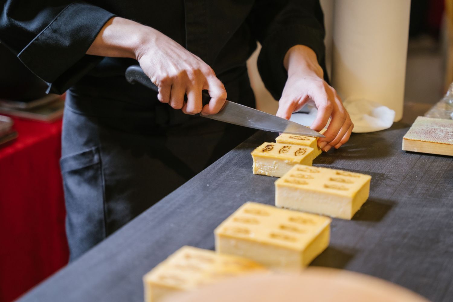 Nicholas Yap slicing his tamago and shrimp into neat and uniform rectangles, perfect for a serving each