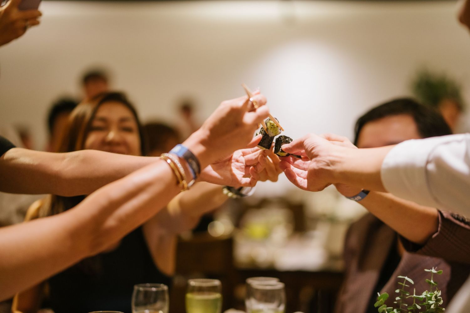 Guests and Makoto Saito Sam toasting to their wasabi rolls before battling the pungency
