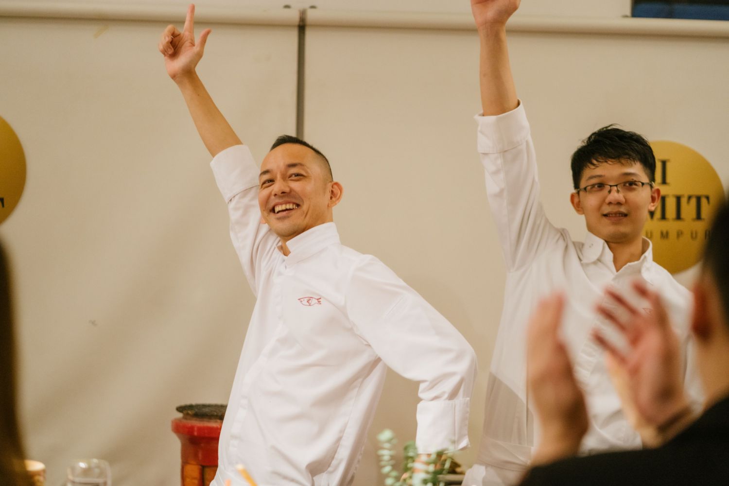 Makoto Saito Sam and his assistant chef holding Saito's signature pose to the diners' delights