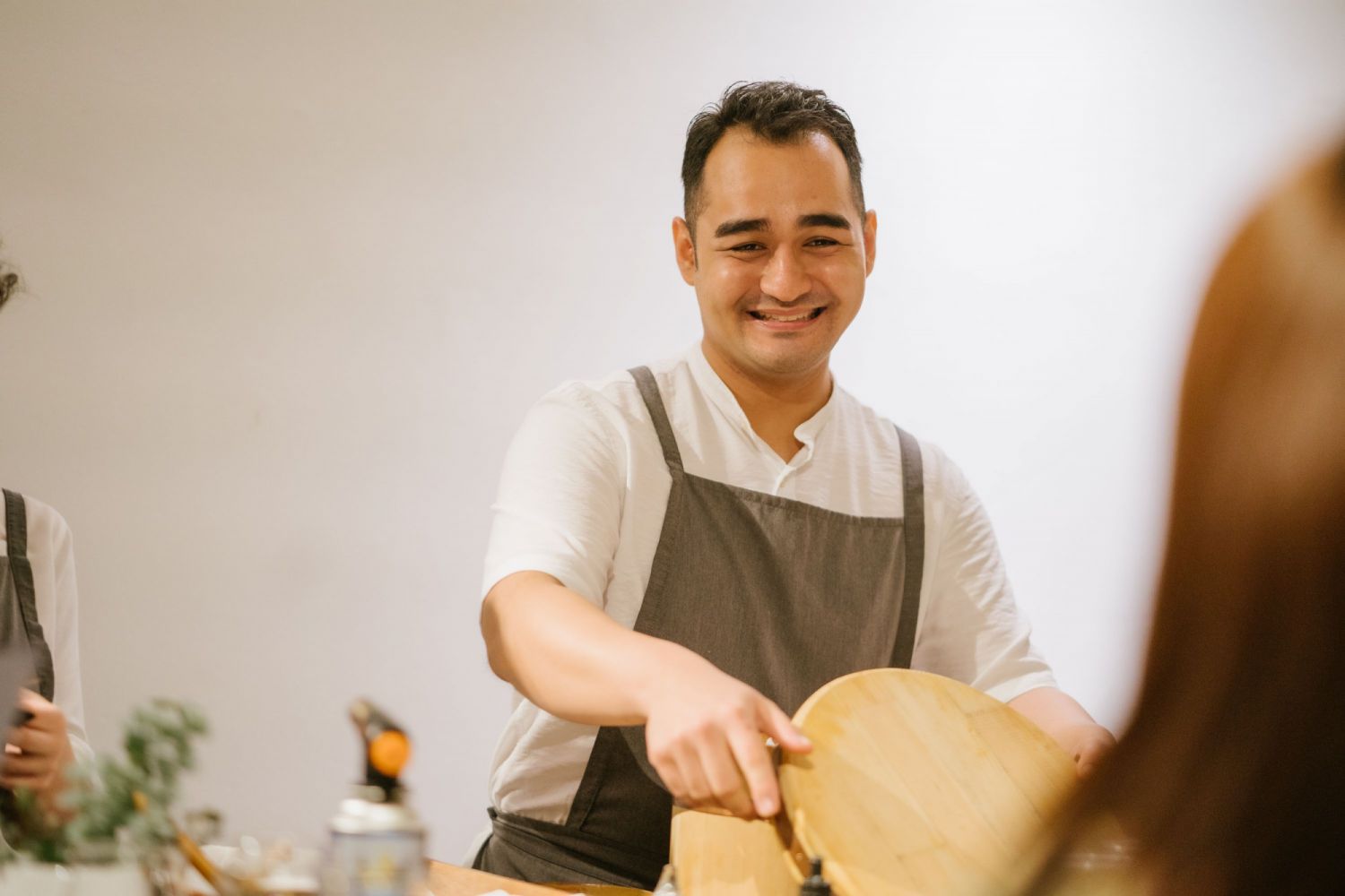 Michael Yee prepping for a service as diners look on
