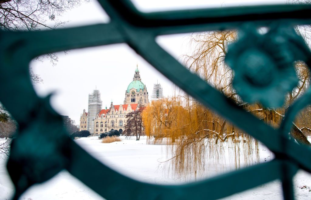 13 February 2021, Lower Saxony, Hanover: Snow covers the frozen Maschteich in front of the New Town Hall in the Maschpark, photographed through the railing of a bridge. Photo: Hauke-Christian Dittrich/dpa (Photo by Hauke-Christian Dittrich/picture alliance via Getty Images)
