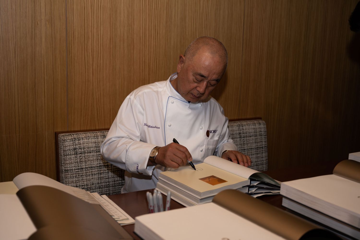Nobu-san autographing his autobiography