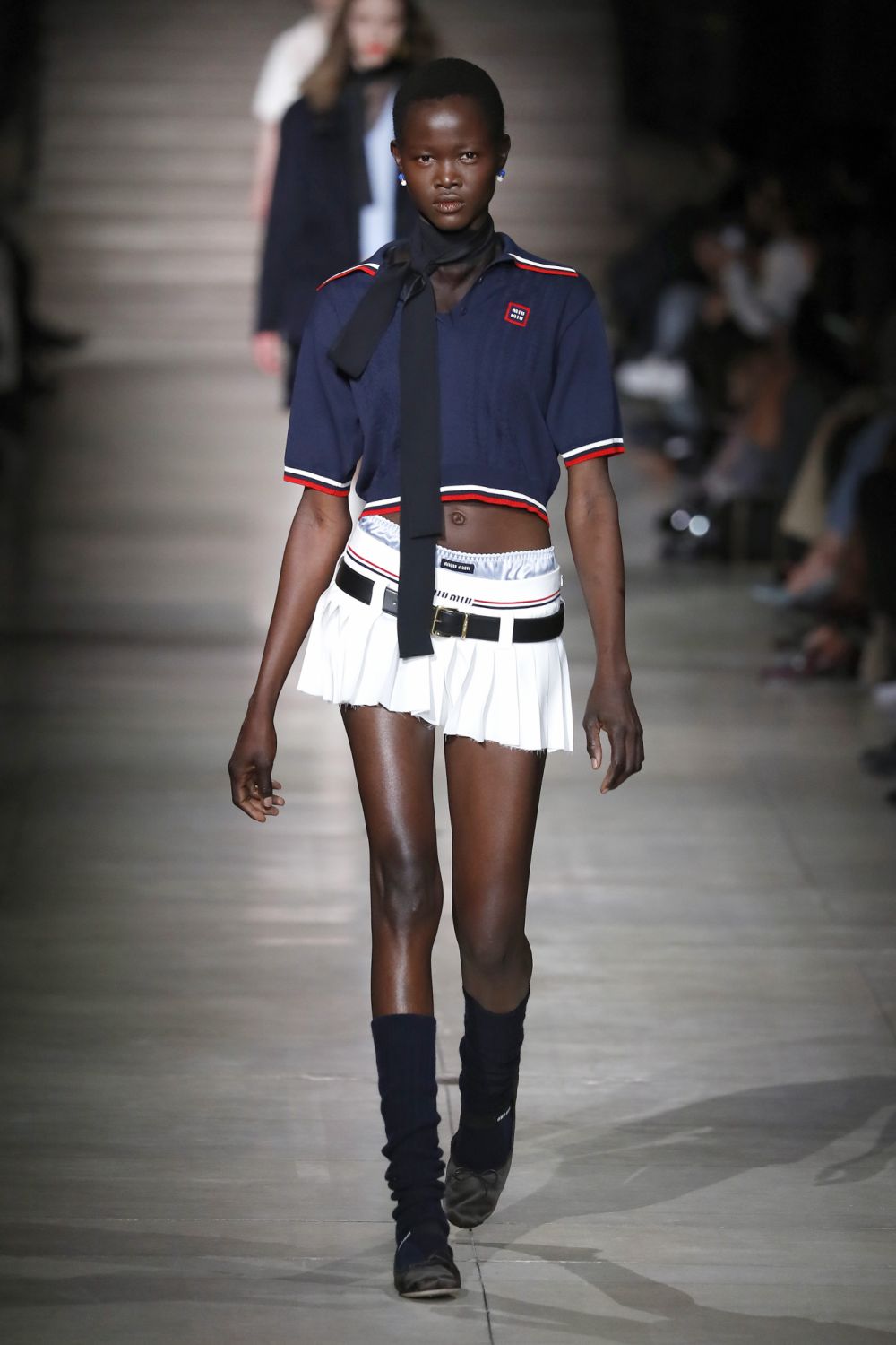 (EDITORIAL USE ONLY - For Non-Editorial use please seek approval from Fashion House) A model walks the runway during the Miu Miu Womenswear Fall/Winter 2022-2023 show as part of Paris Fashion Week on March 8, 2022 in Paris, France. (Photo by Estrop/Getty Images)