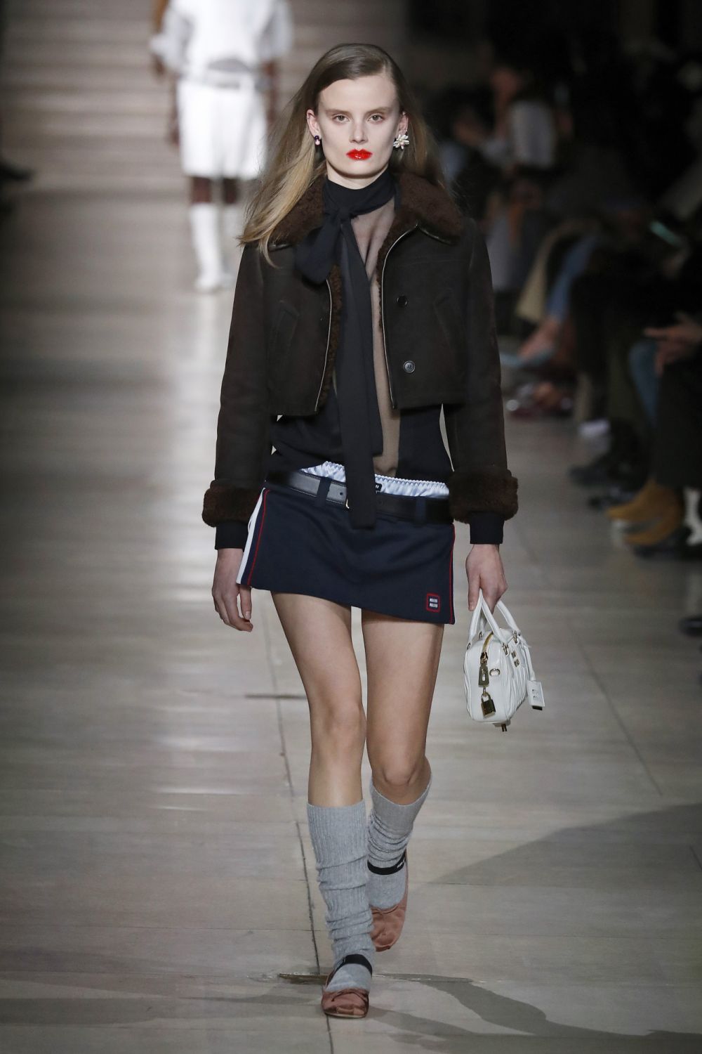 (EDITORIAL USE ONLY - For Non-Editorial use please seek approval from Fashion House) A model walks the runway during the Miu Miu Womenswear Fall/Winter 2022-2023 show as part of Paris Fashion Week on March 8, 2022 in Paris, France. (Photo by Estrop/Getty Images)
