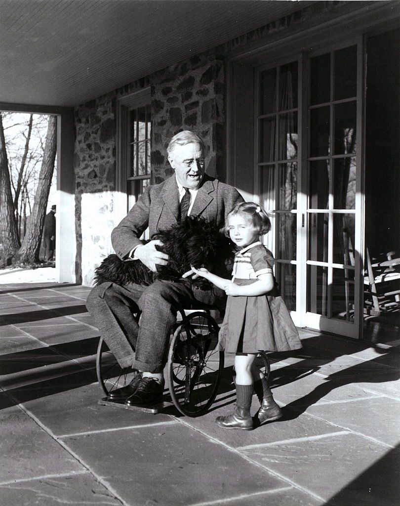 Franklin D. Roosevelt with Fala his dog and Ruthie Bie in Hyde Park, New York, 1941. There were few images taken showing President Roosevelt in his wheelchair. (Photo by: Universal History Archive/Universal Images Group via Getty Images)