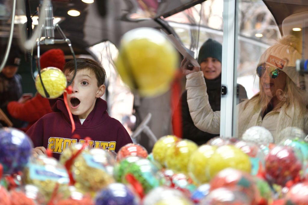 DENVER, CO - DECEMBER 04: Aden Foster of Colorado Springs wins a prize on the ebay claw machine as Codie Murphy cheers him on at the 'Did You Check eBay?' Holiday Airstream at Christkindl Market on December 4, 2017 in Denver, Colorado. (Photo by Tom Cooper/Getty Images for eBay)